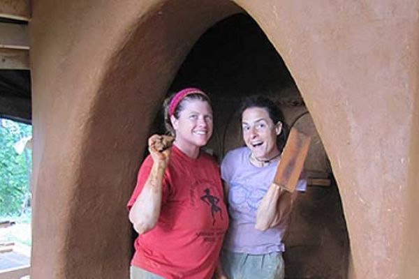 Mollie Curry and student plastering an arch