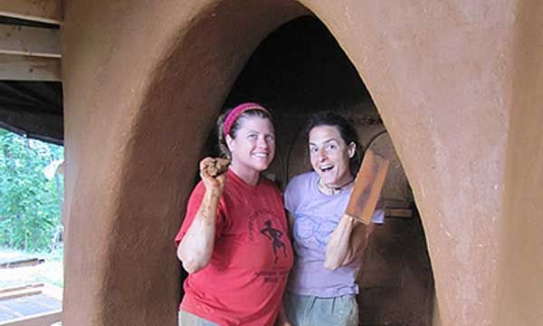 Mollie Curry and student plastering an arch