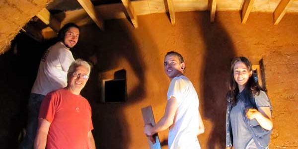 Plastering a wall in a natural built house