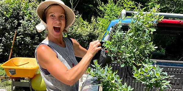 Monique and a plant at a community workday