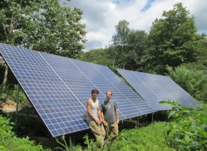 Brandon and Farmer with the microgrid solar panels